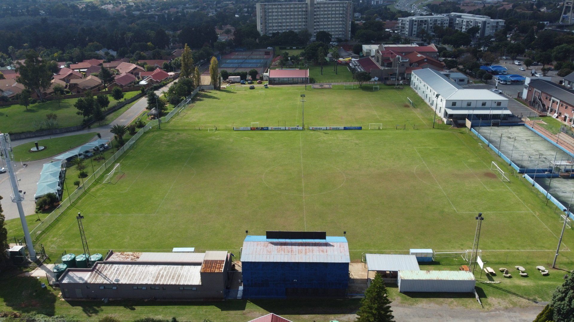an aerial view of a soccer field with buildings in the background .