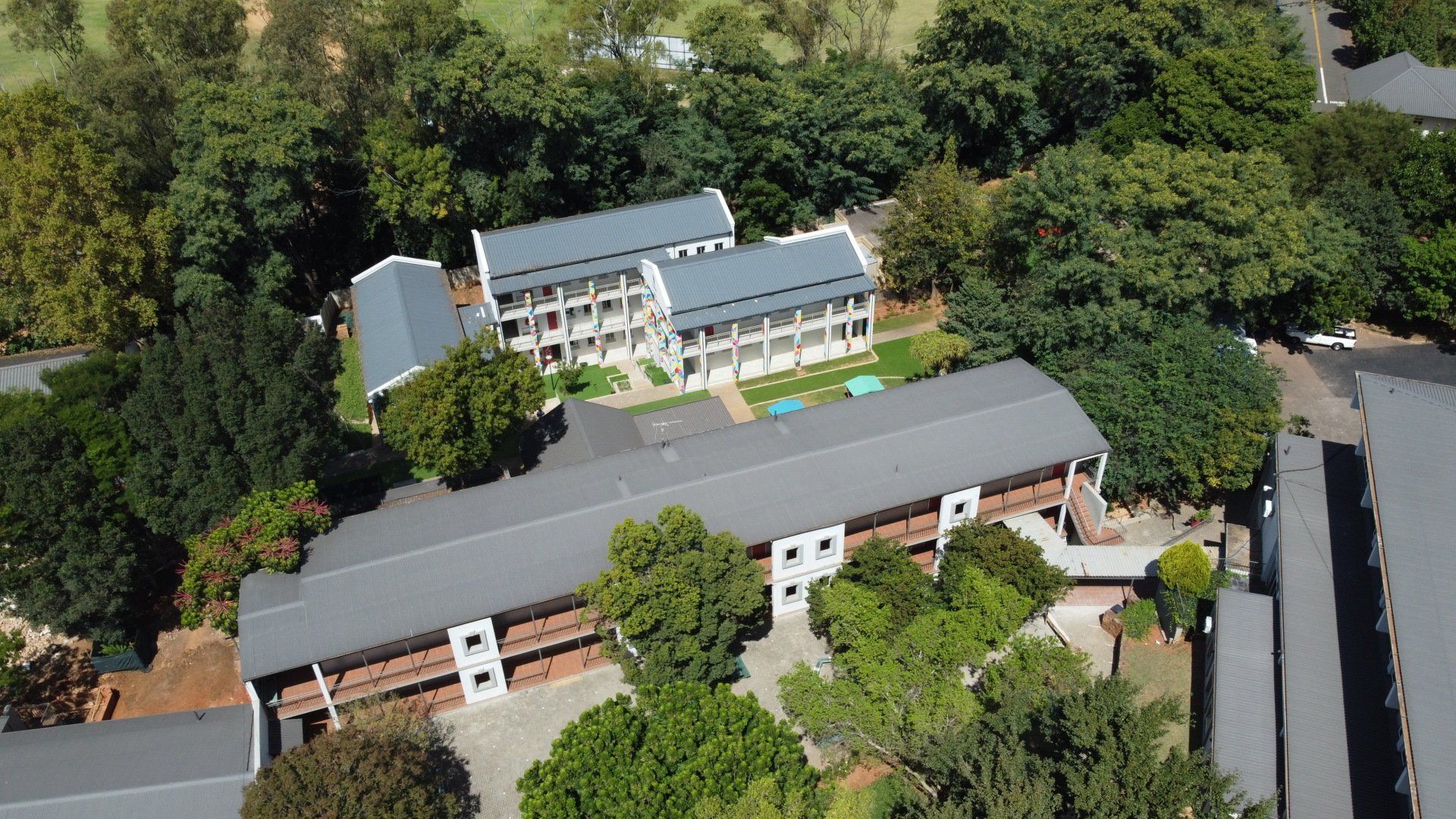 an aerial view of a large building surrounded by trees .