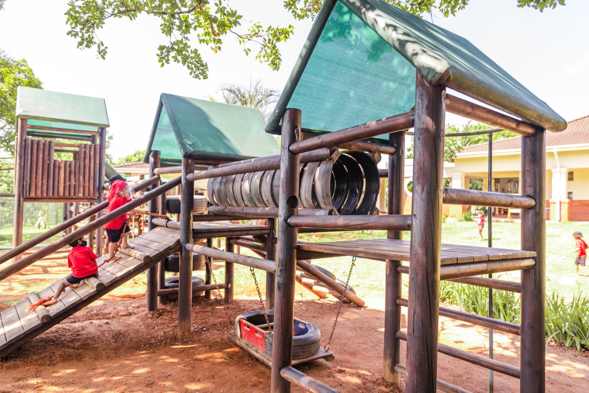 a group of children are playing on a wooden playground .