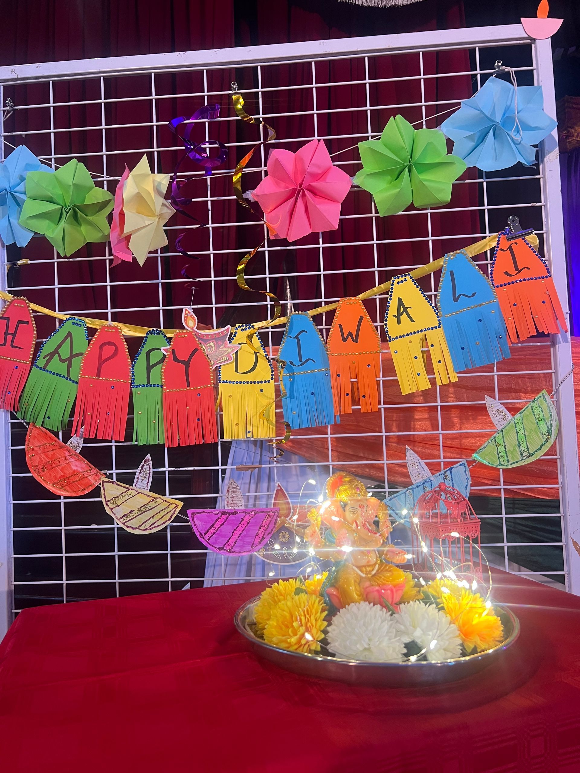 A table with a bowl of flowers and a sign that says happy birthday