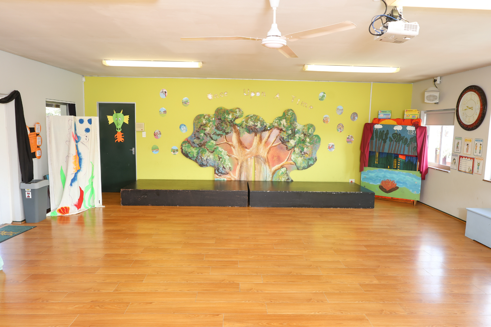 a young boy is playing a piano in a classroom .