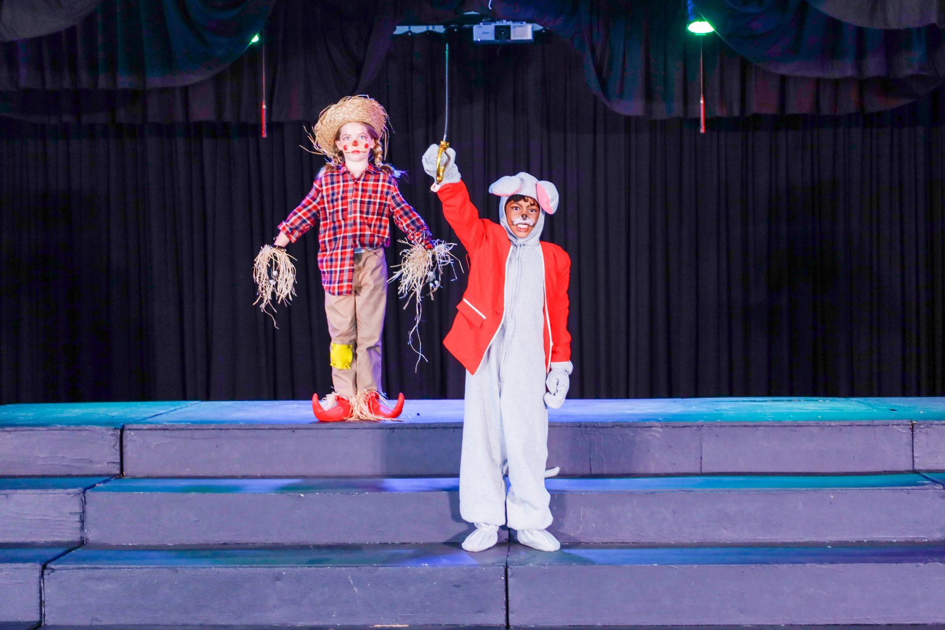 an empty drama studio with a wooden floor and a large mirror .
