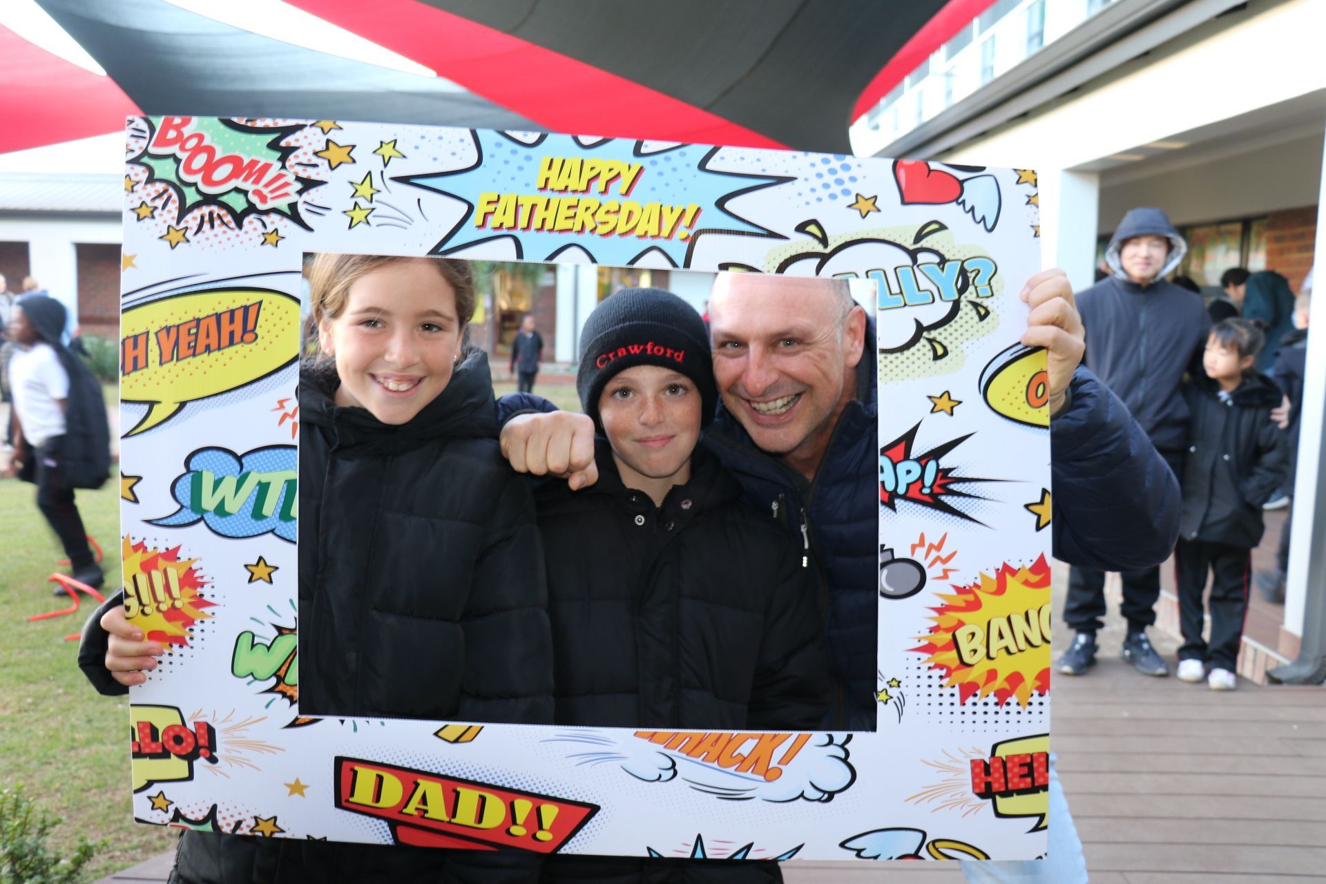 A man is holding a picture frame that says happy fathers day