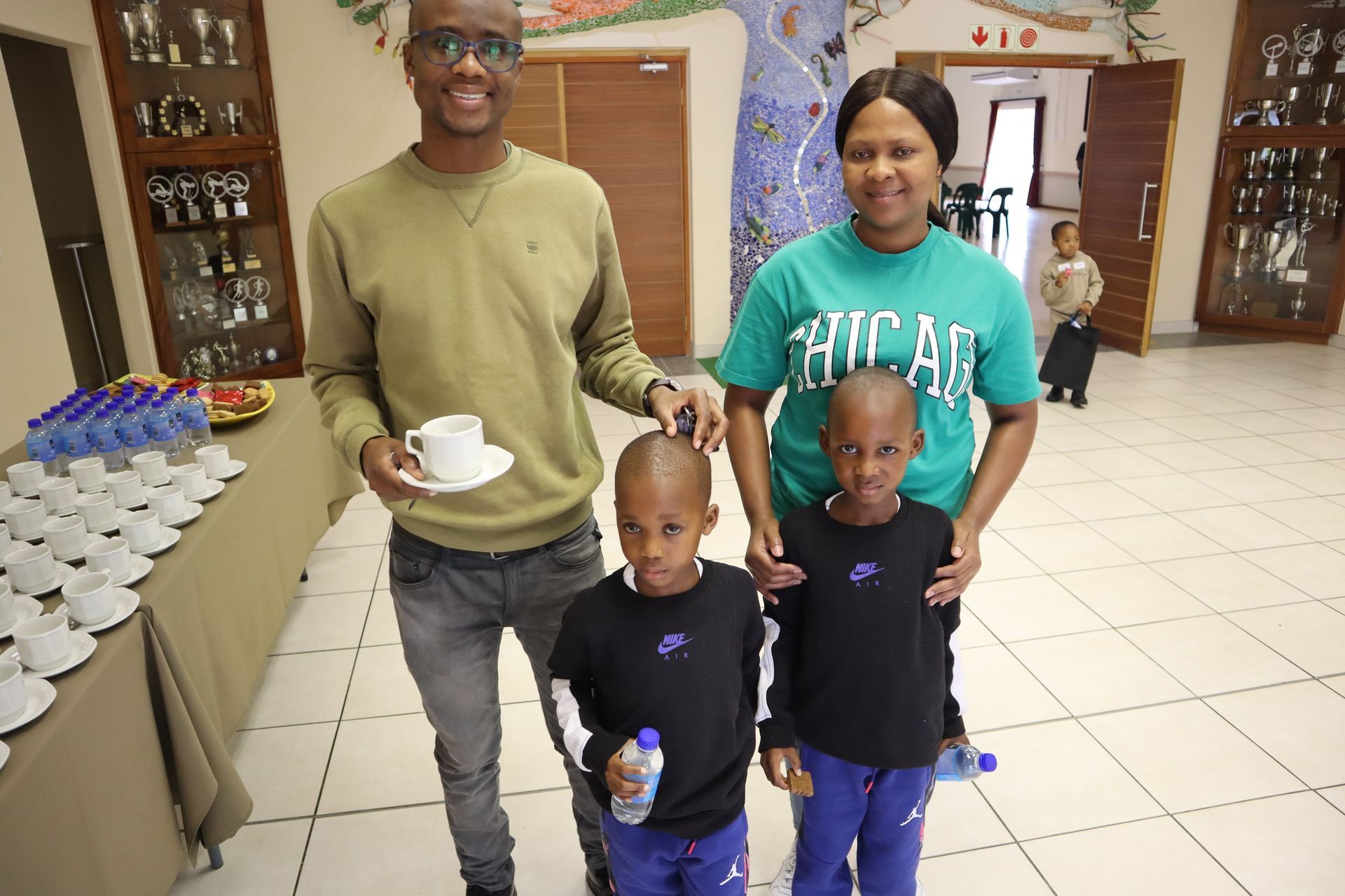 A family is posing for a picture in a room.