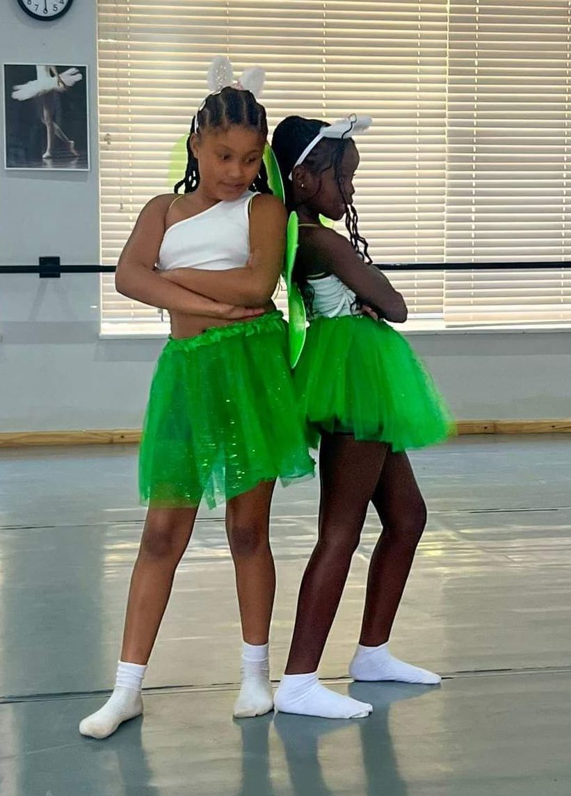 a girl is standing in a dance studio .