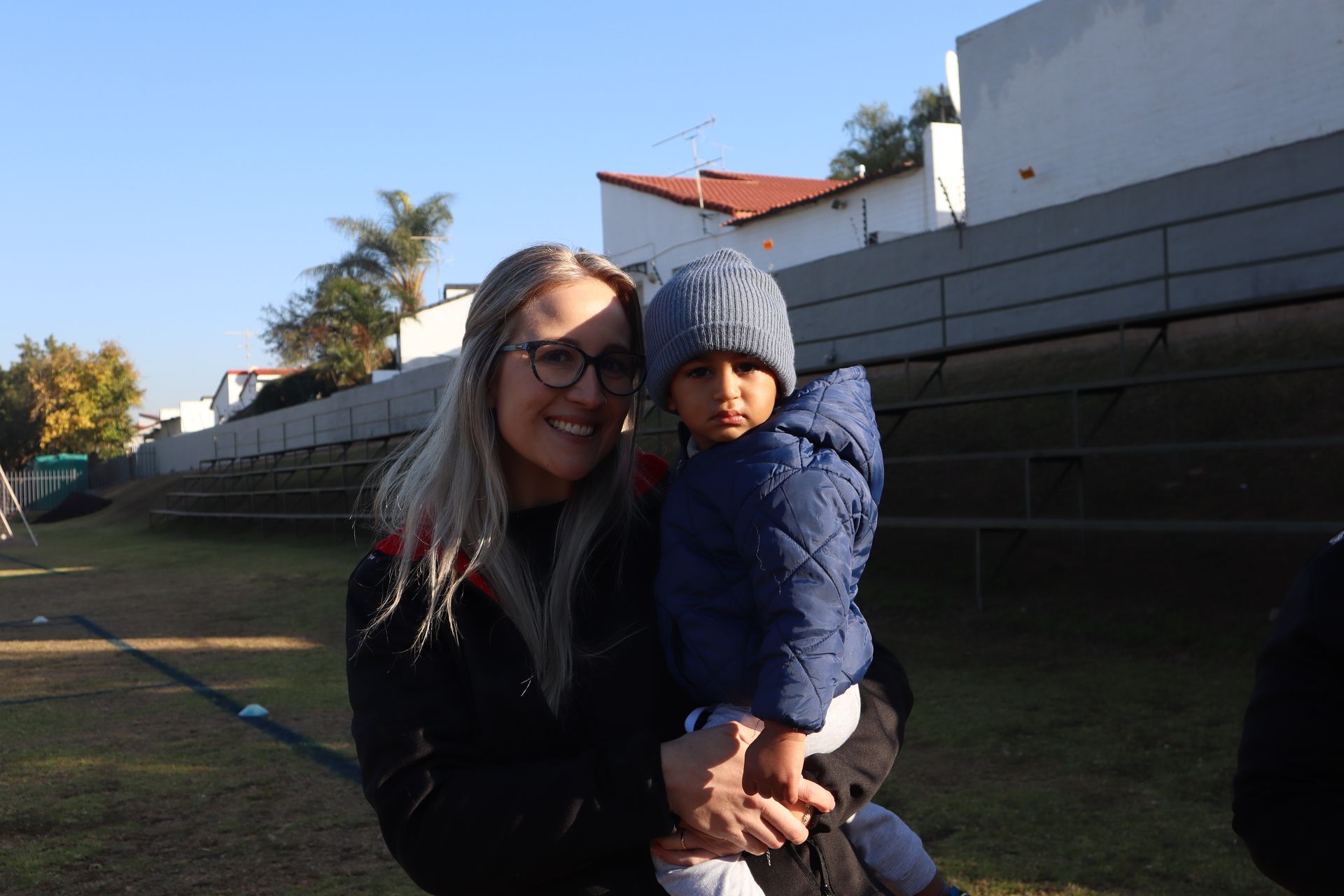 A woman is holding a small child in her arms.