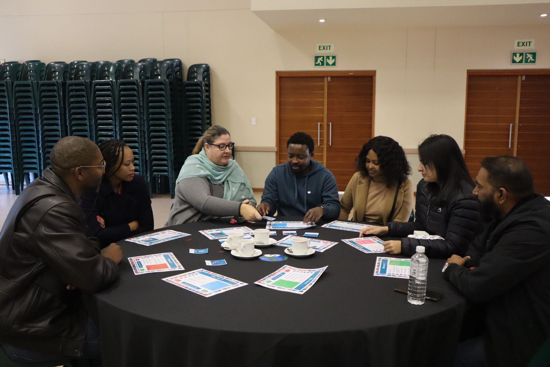 A group of people are sitting around a table in a room.