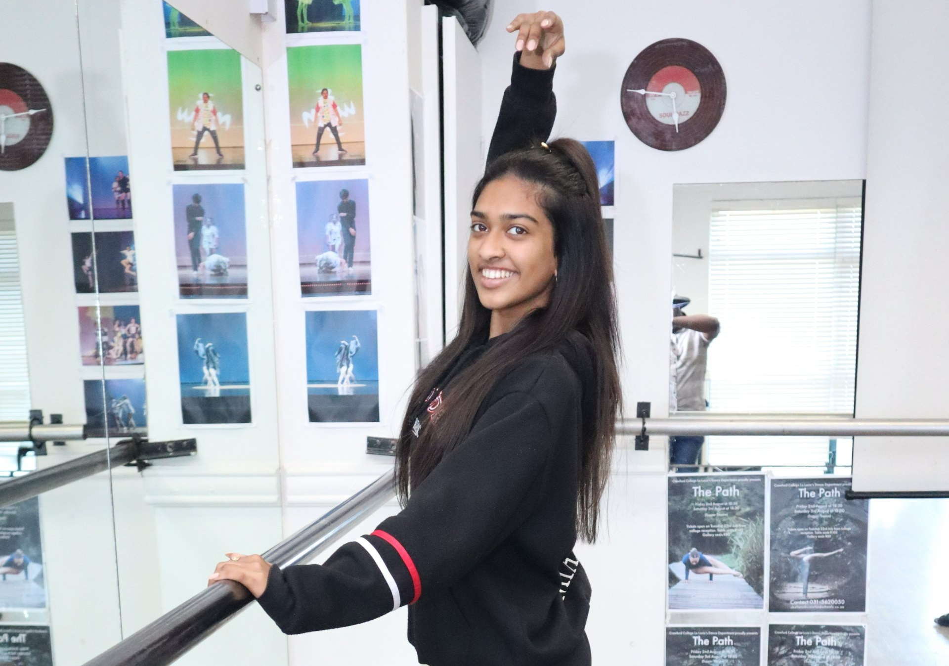 a girl is standing in a dance studio .