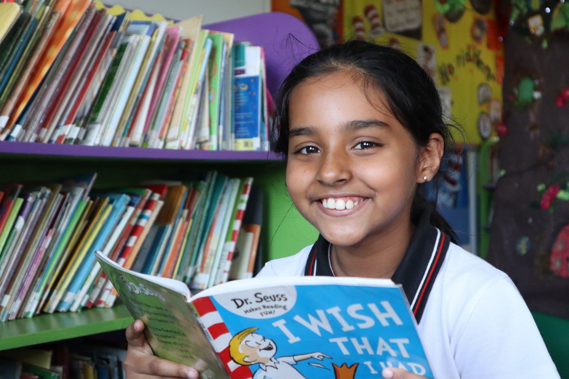 a girl is reading a book called i wish that i had