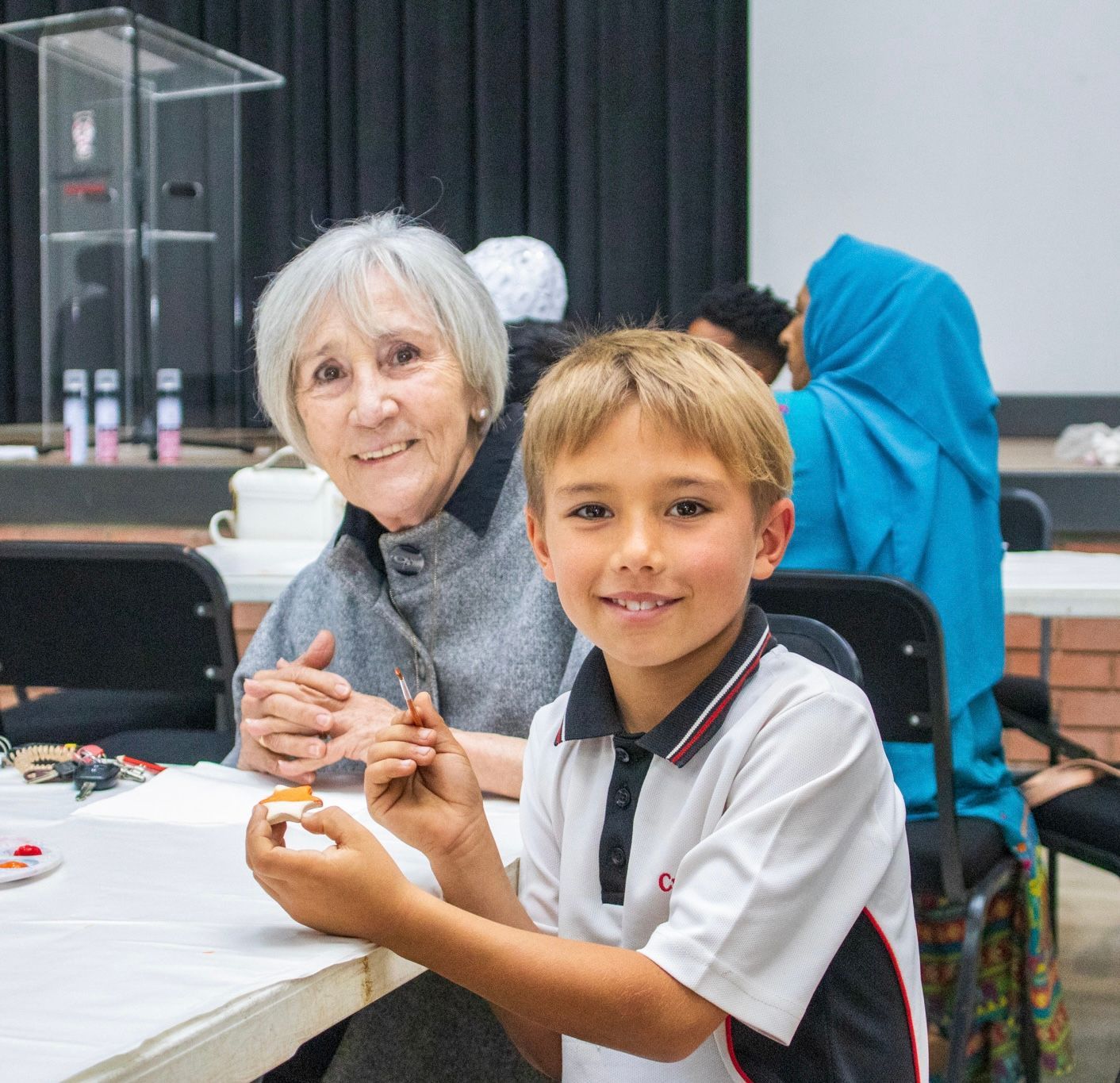 A woman and a boy are sitting at a table