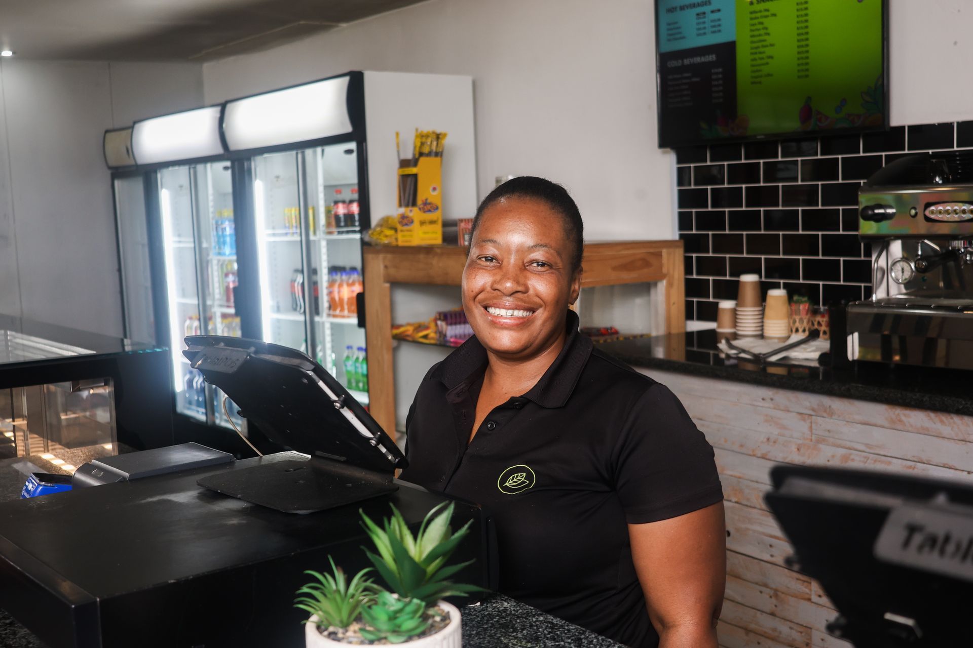 a canteen with a long wooden counter and a clock on the wall .