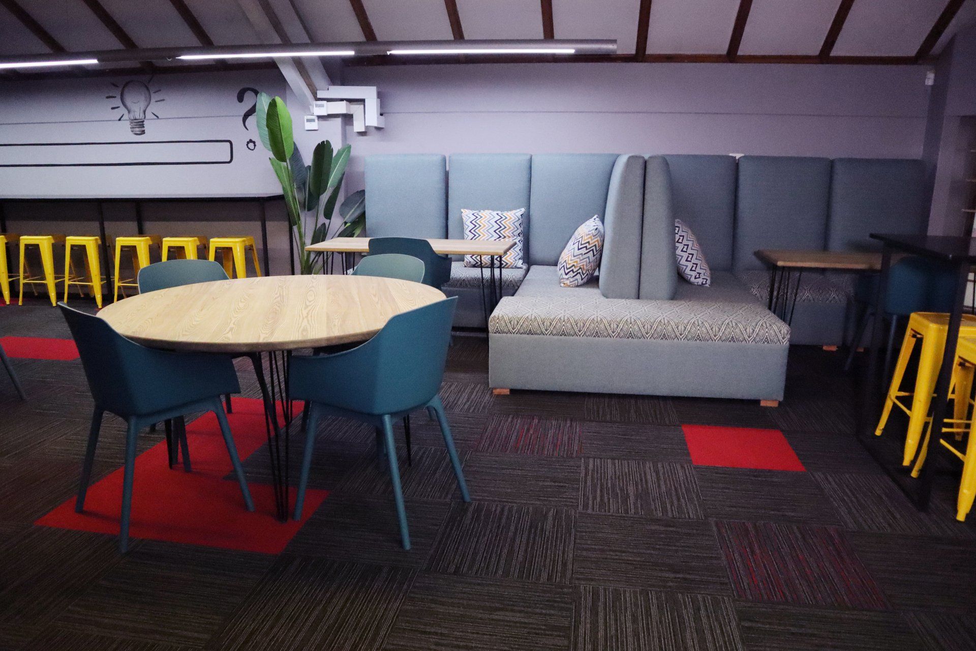 a room with tables and chairs and a couch .
