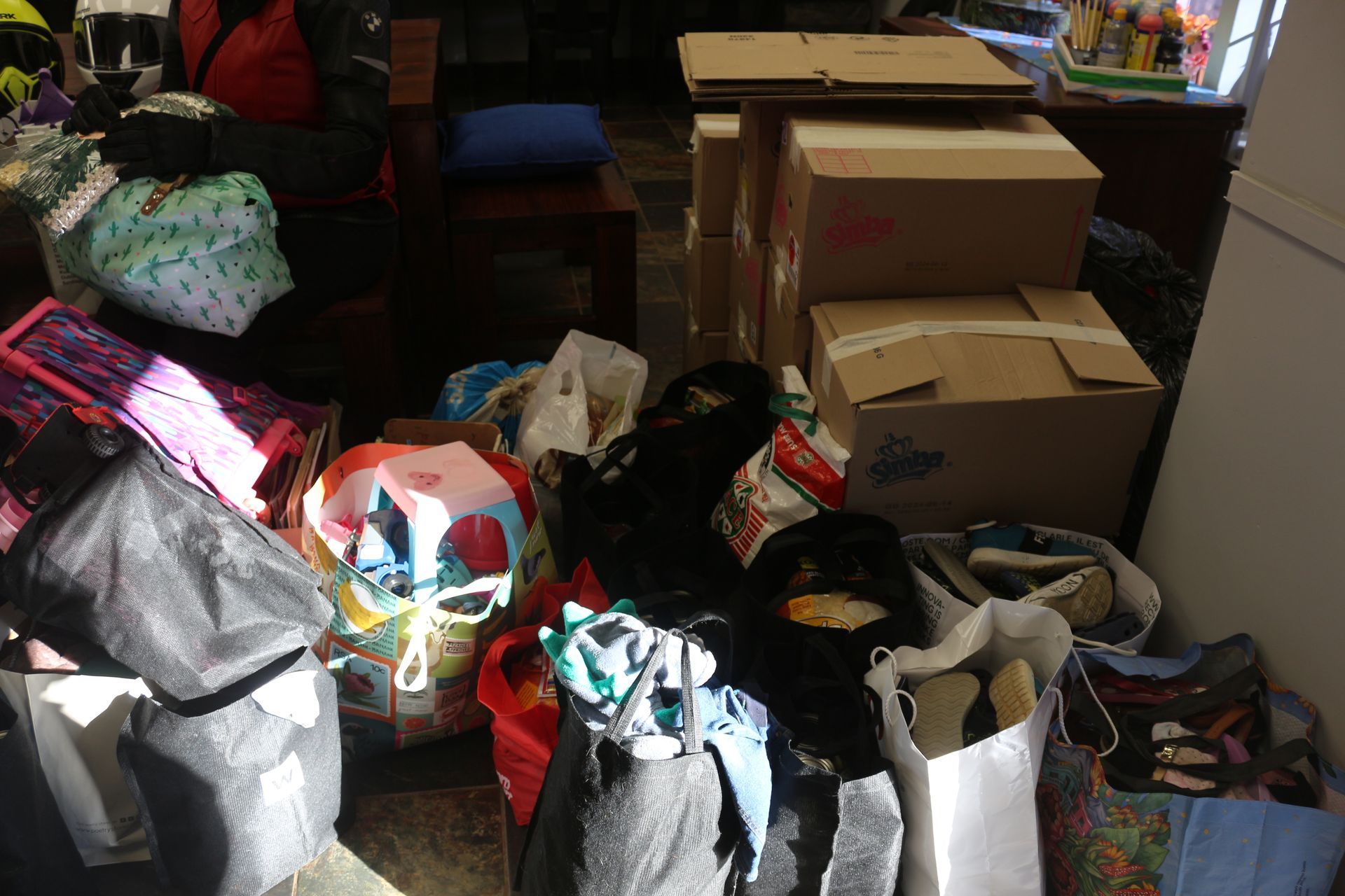A pile of boxes and bags in a living room