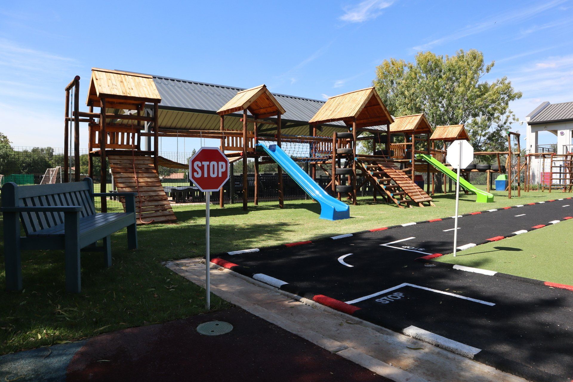 a stop sign is in the middle of a playground .
