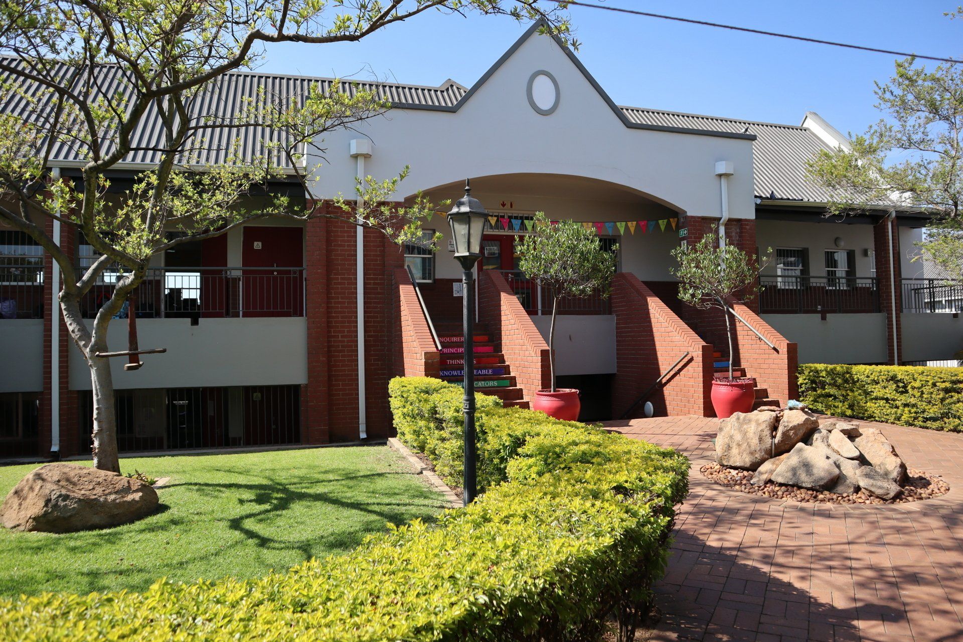 a large brick building with stairs leading up to it