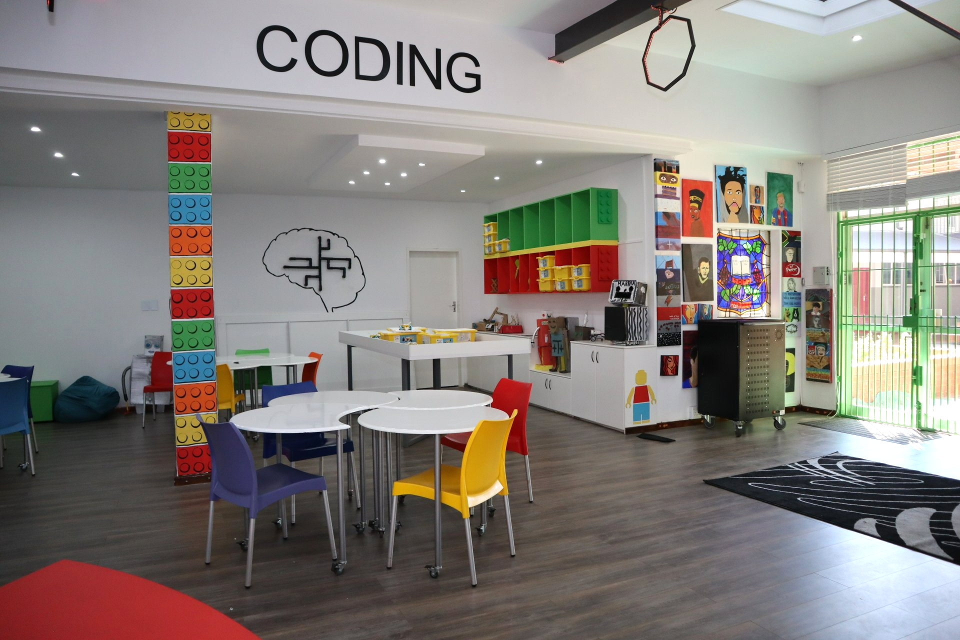 a room with tables and chairs and a sign that says coding