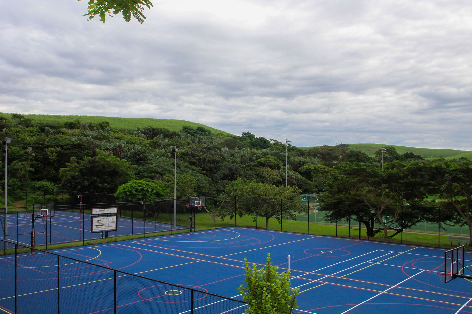 an aerial view of a sport field with a building in the background .