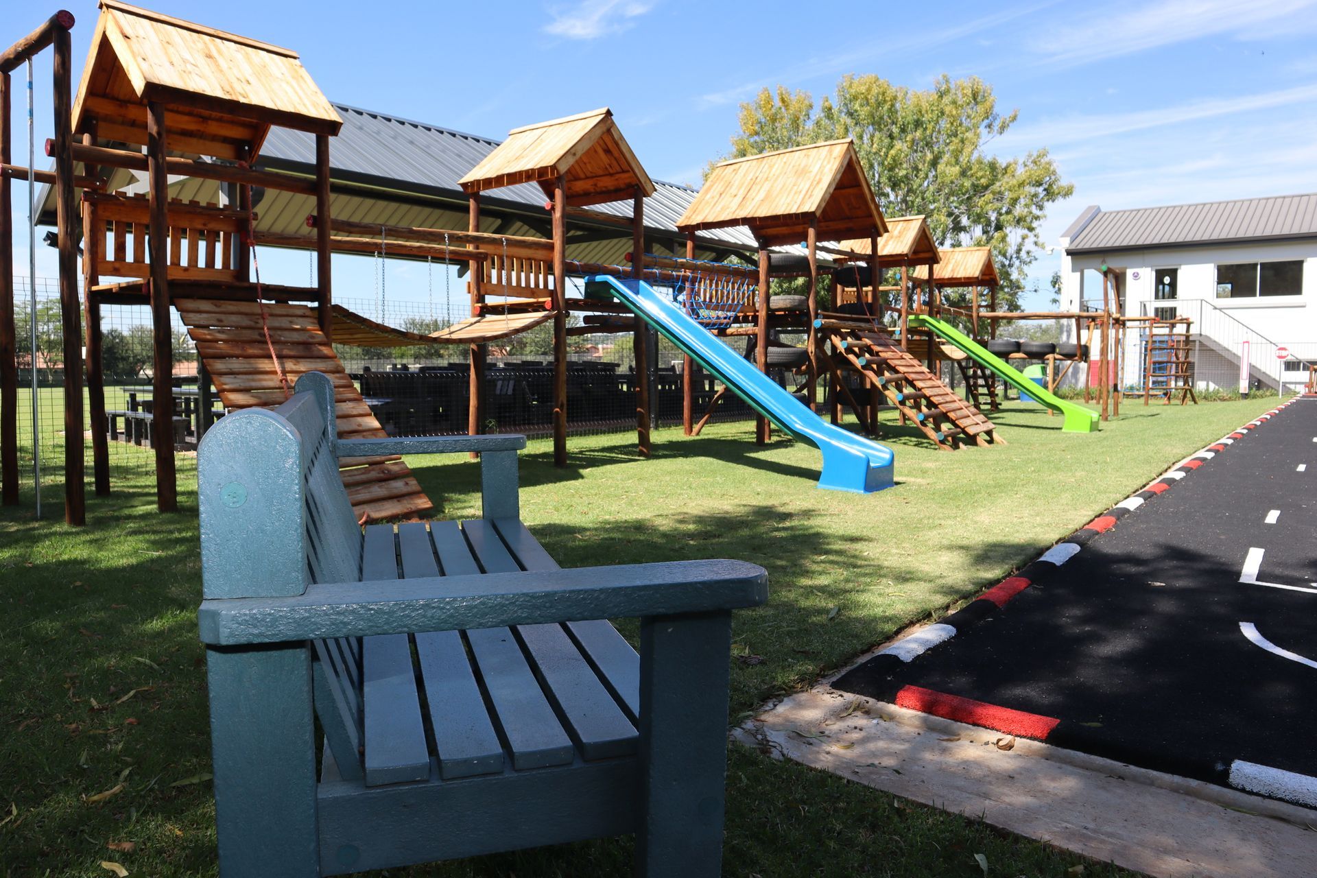 A playground with a bench in front of it