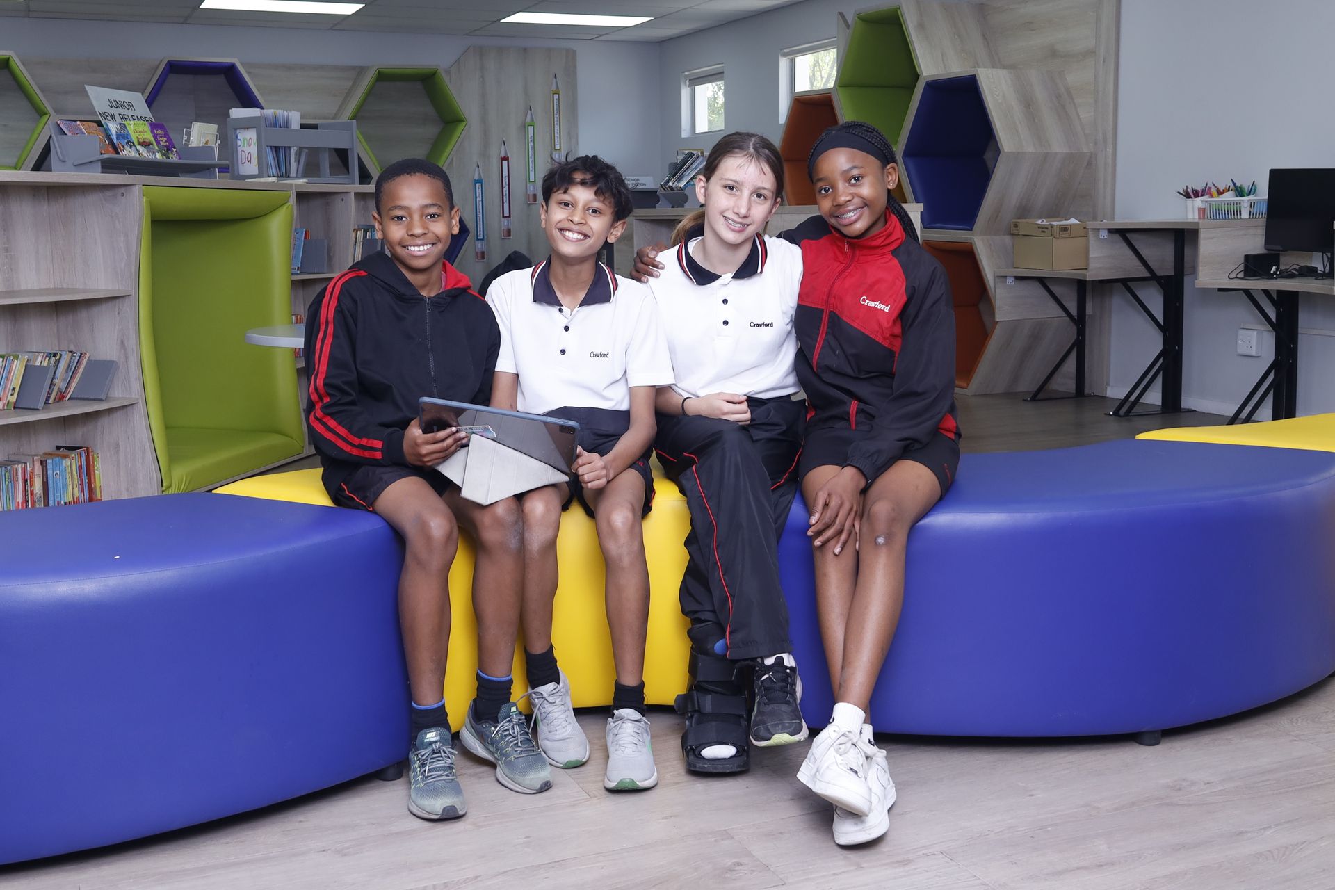 a young boy is looking at books on a bookshelf in a library .