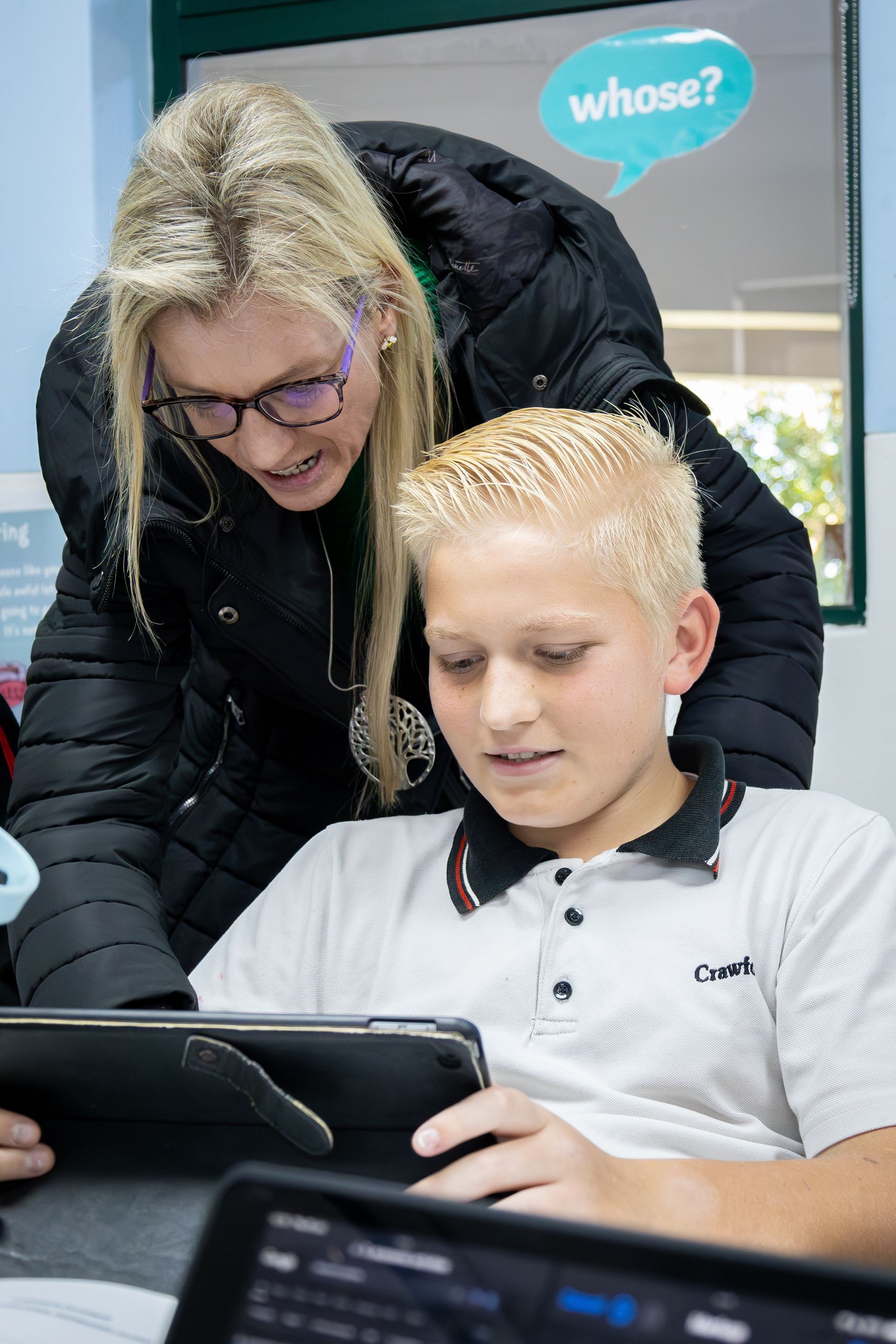 a young girl is laying on the floor reading a book .