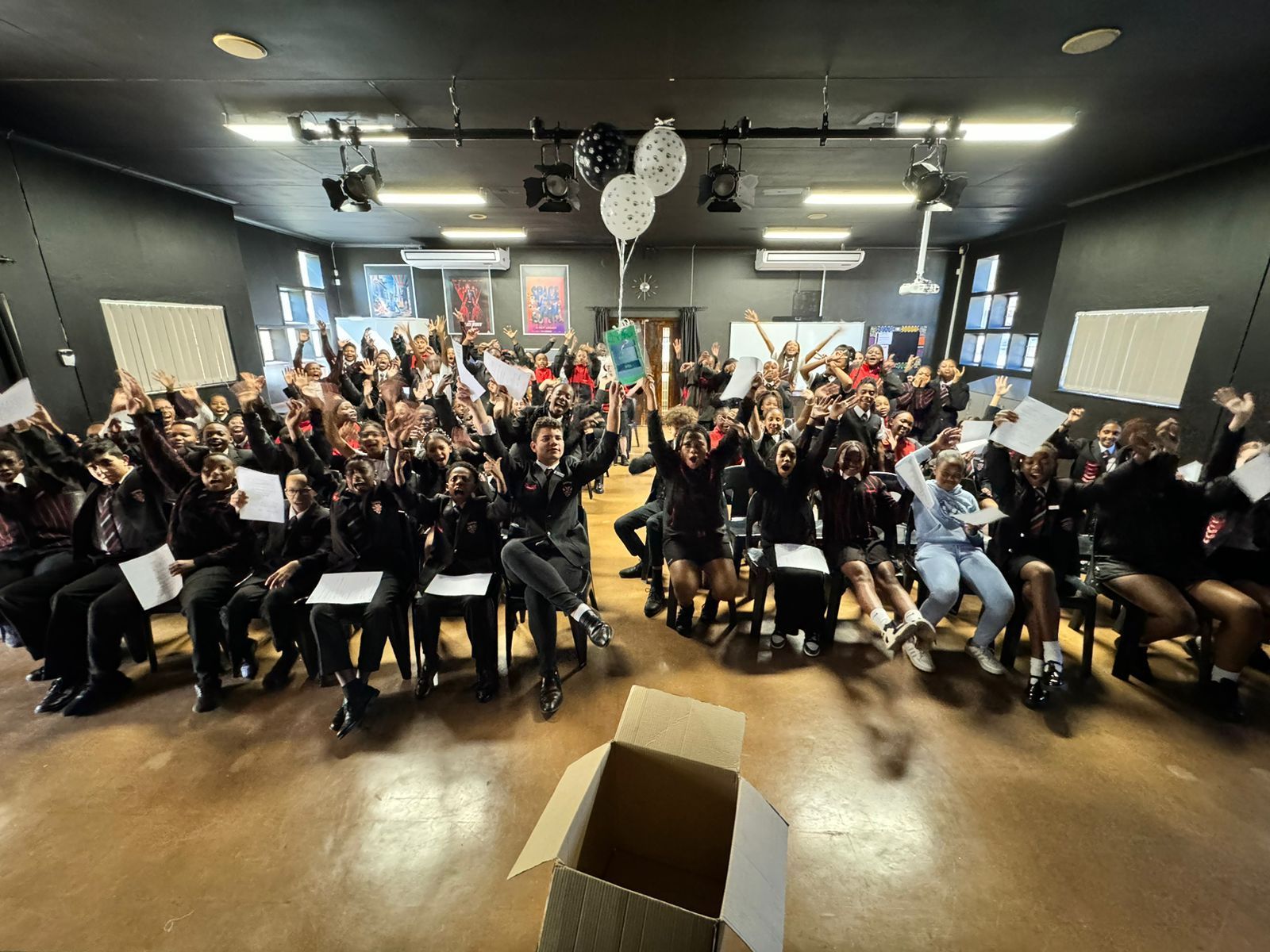 A large group of people are posing for a picture in a room.