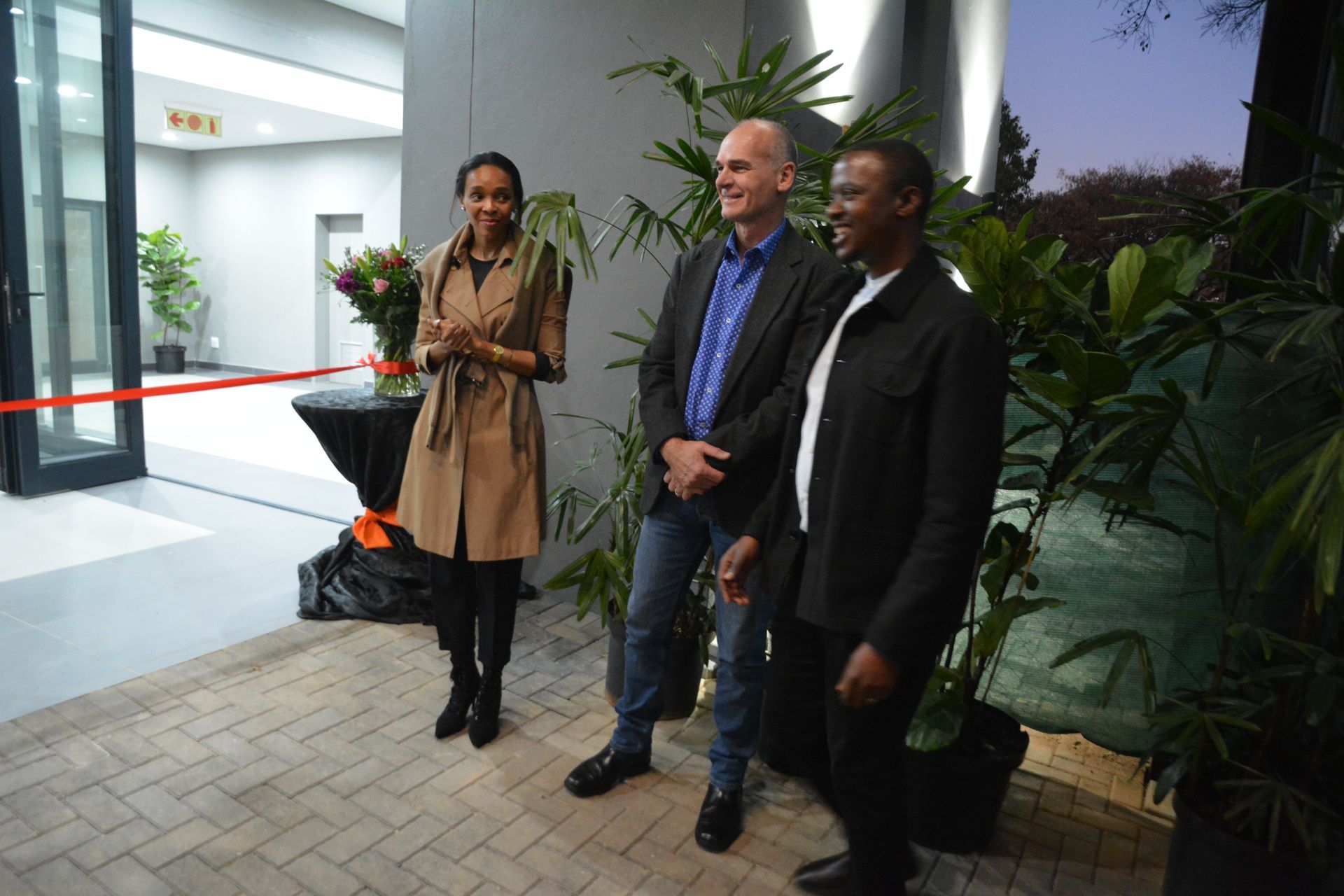 A group of people standing next to each other in front of a building.