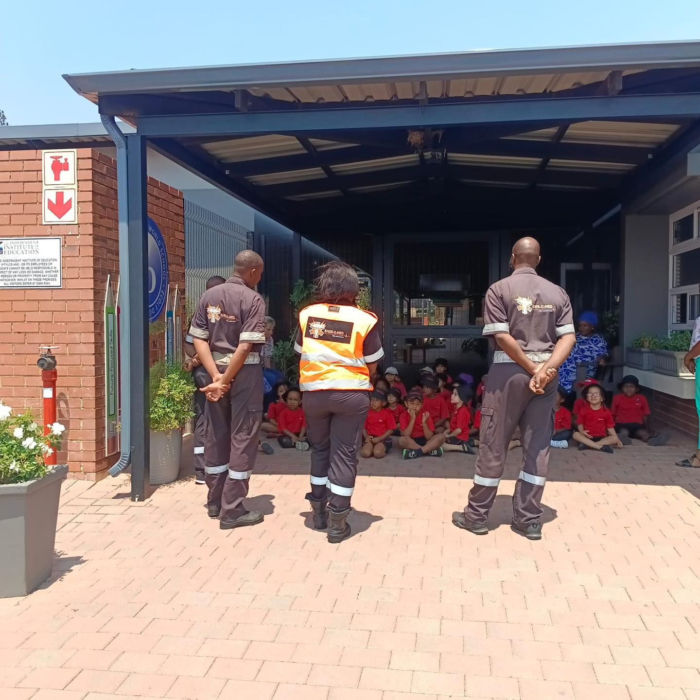 A group of people are standing in front of a building