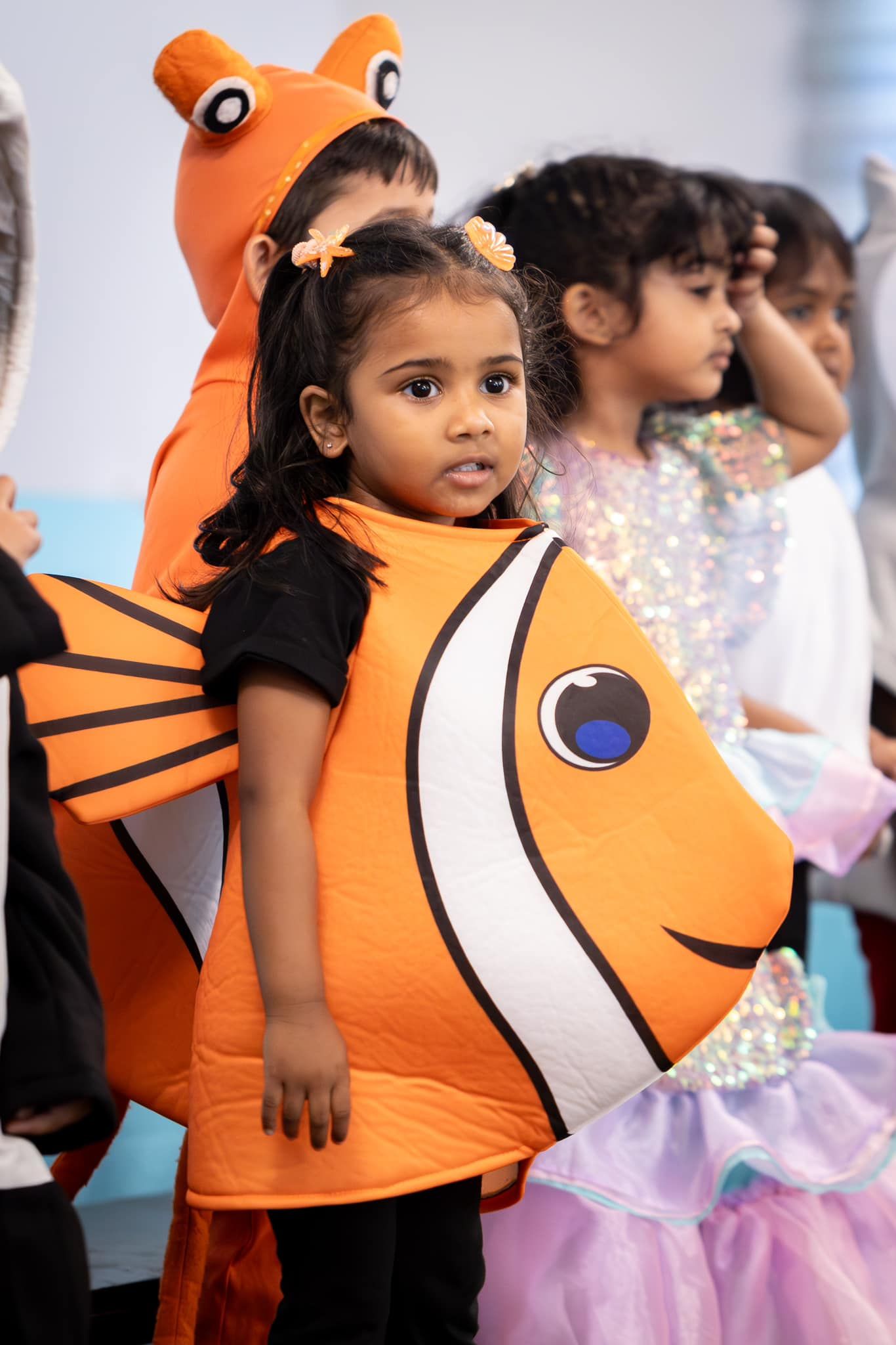A group of children are dressed up in costumes.
