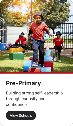 Child in red shirt stepping on colorful blocks in a playground.
