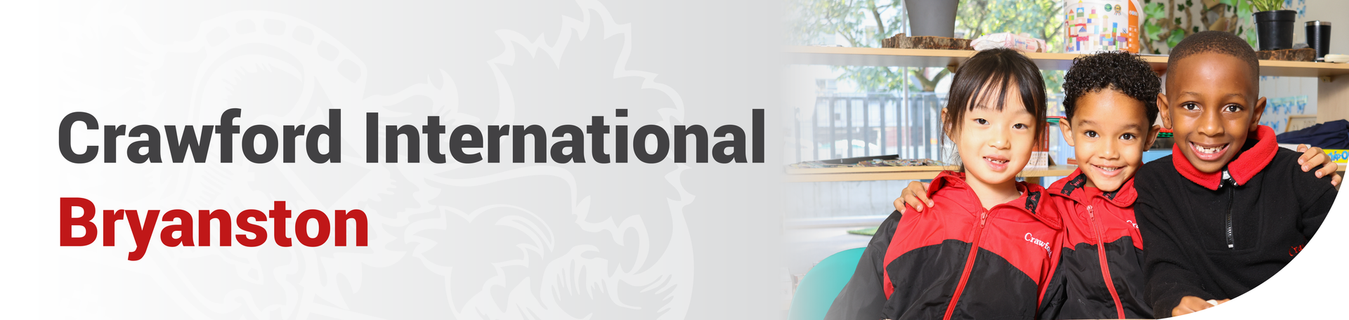 A boy is standing in front of a sign that says crawford international bryanston