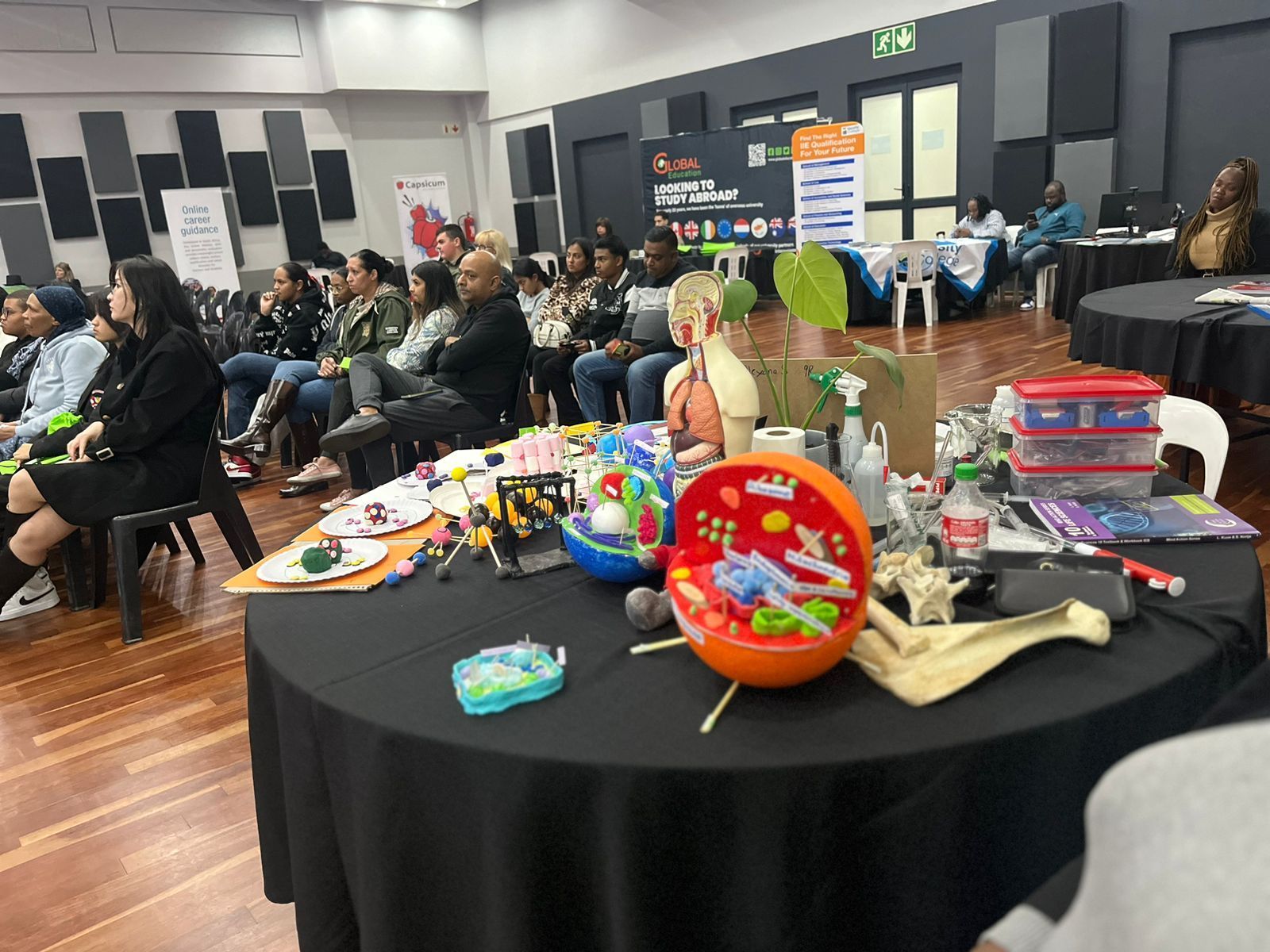 A group of people are sitting around a table with toys on it.