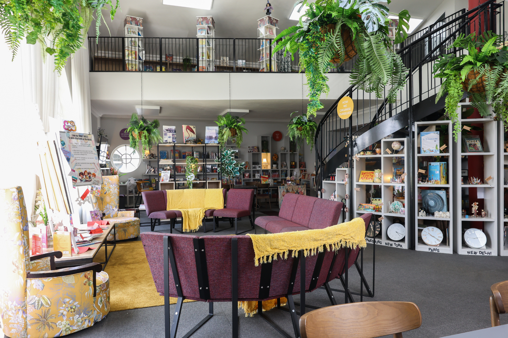 a group of children are sitting on the floor listening to a teacher read a book .