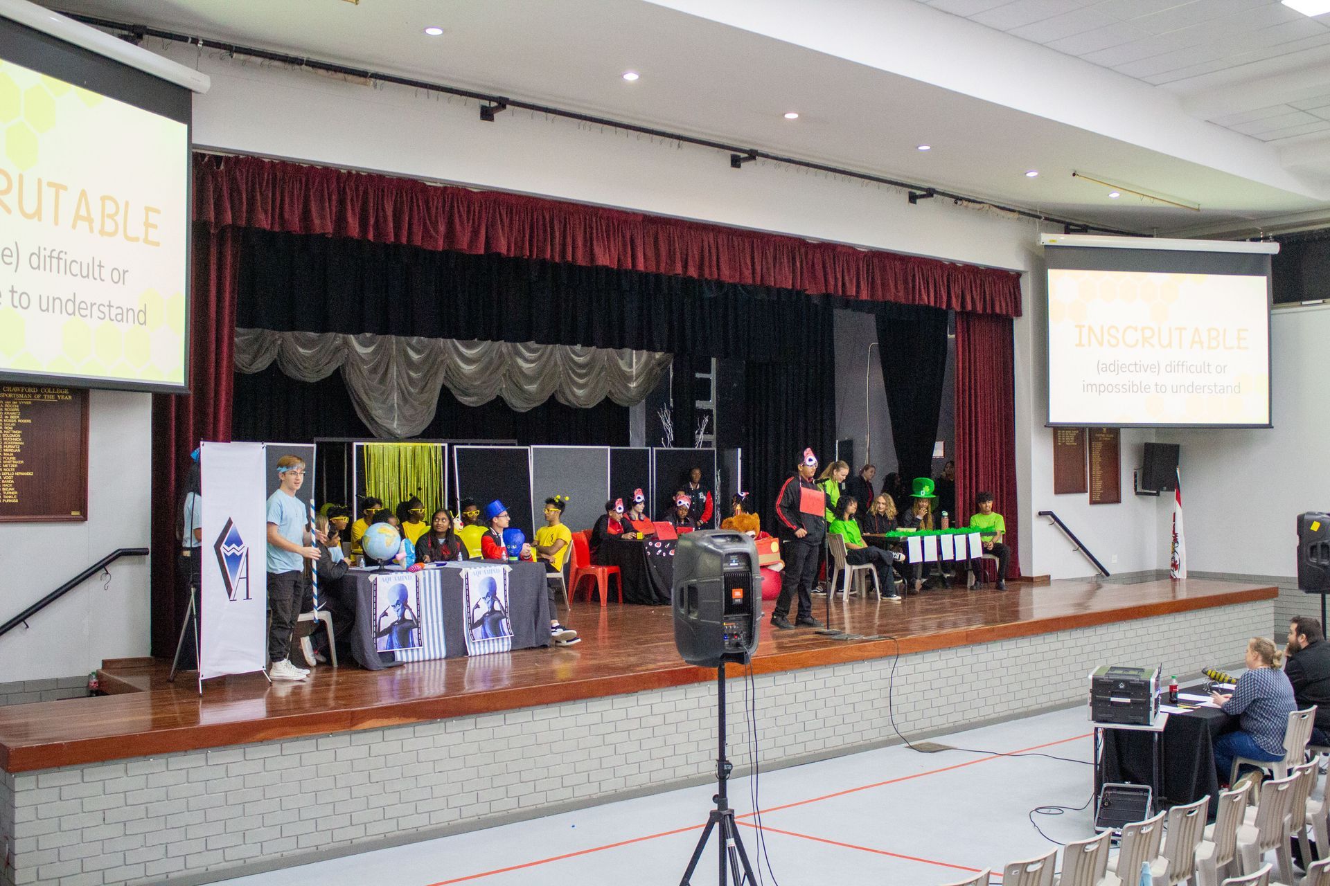 A group of people are standing on a stage in front of a large screen that says portable