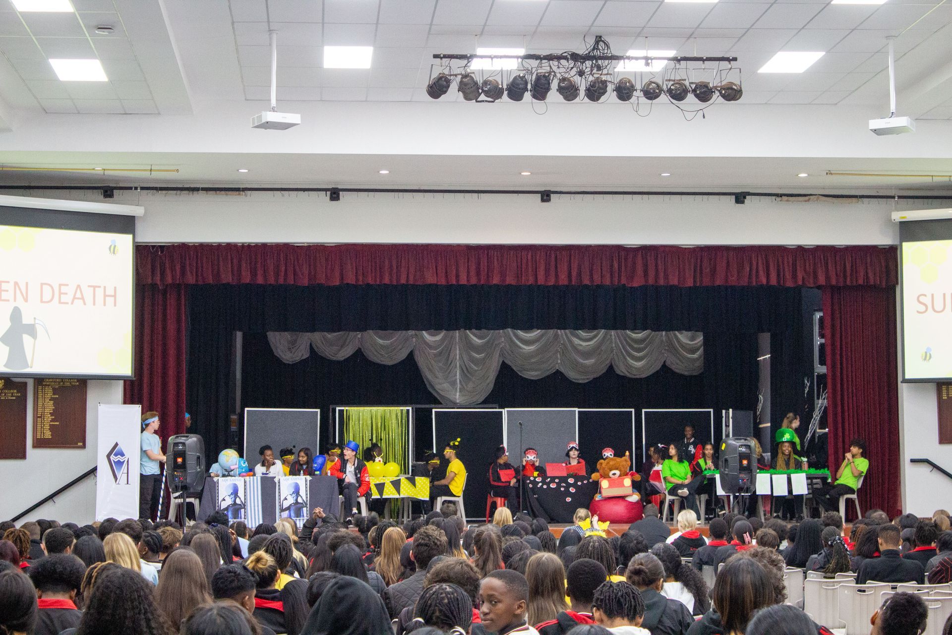 A large group of people are sitting in a large auditorium.