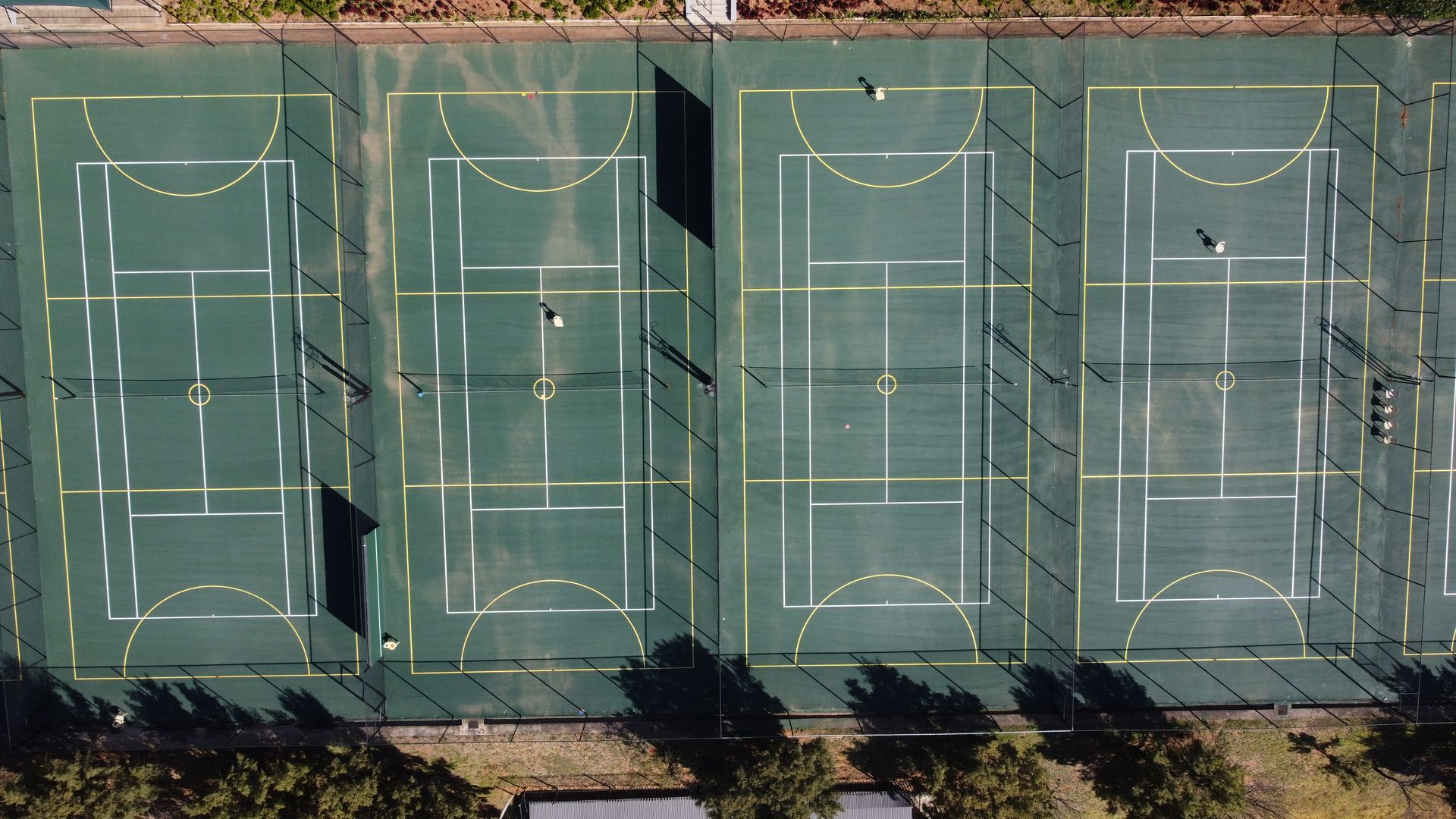 an aerial view of a tennis court and a netball court .