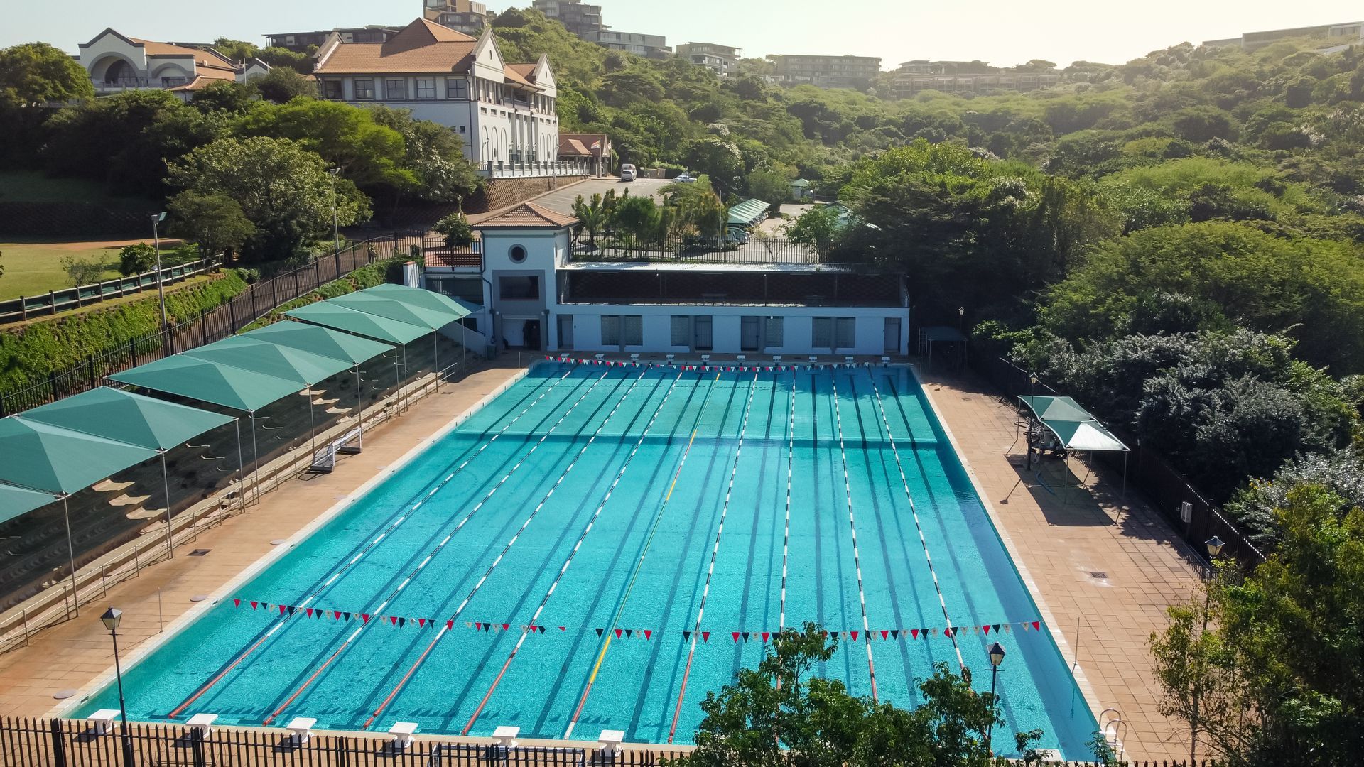 a student is swimming in a pool with the number 5 in the background