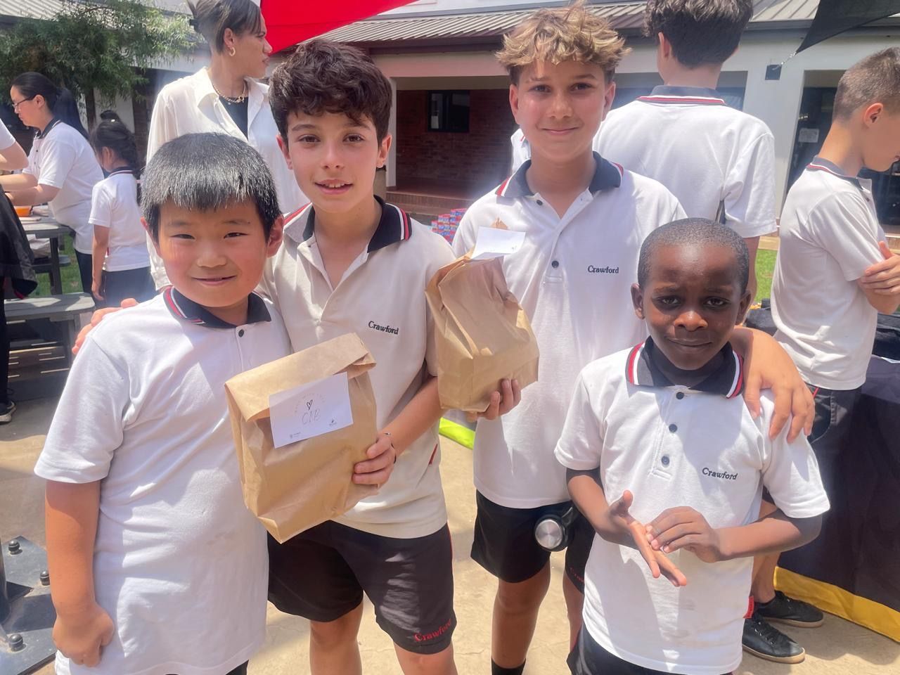 A group of young boys in school uniforms are posing for a picture.