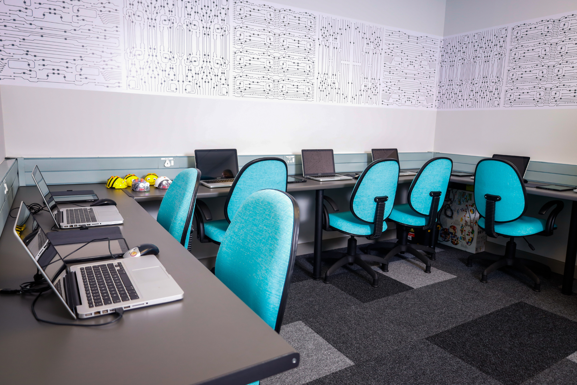 a person in a red shirt is typing on a black keyboard