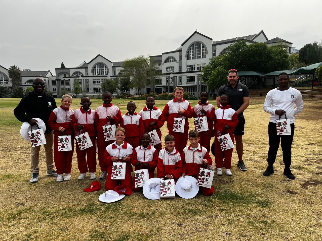 A group of children are posing for a picture in a field.