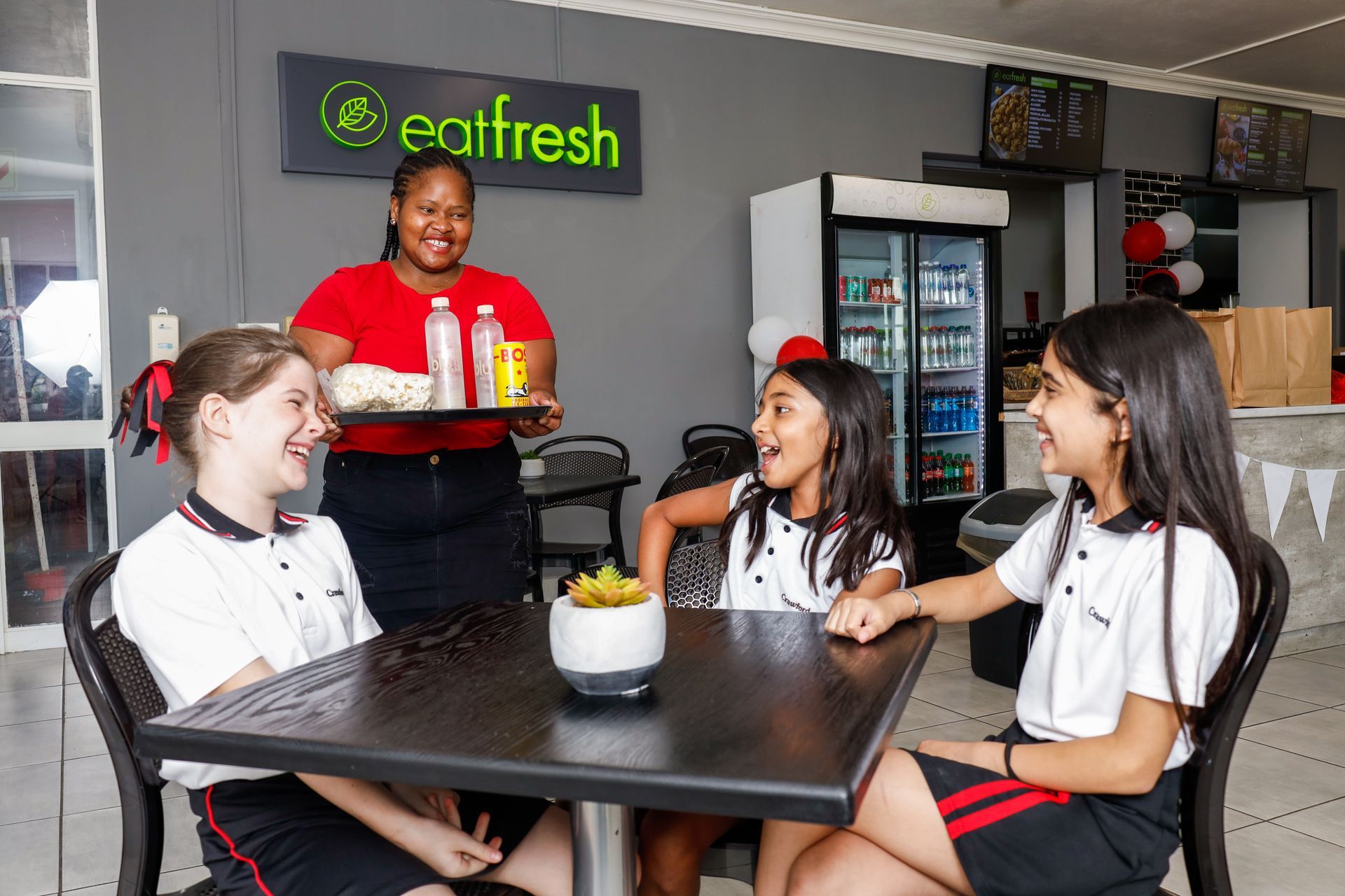 a bottle of water sits on a counter in a restaurant