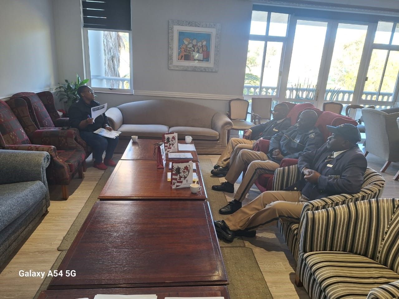 A group of people are sitting in a living room.