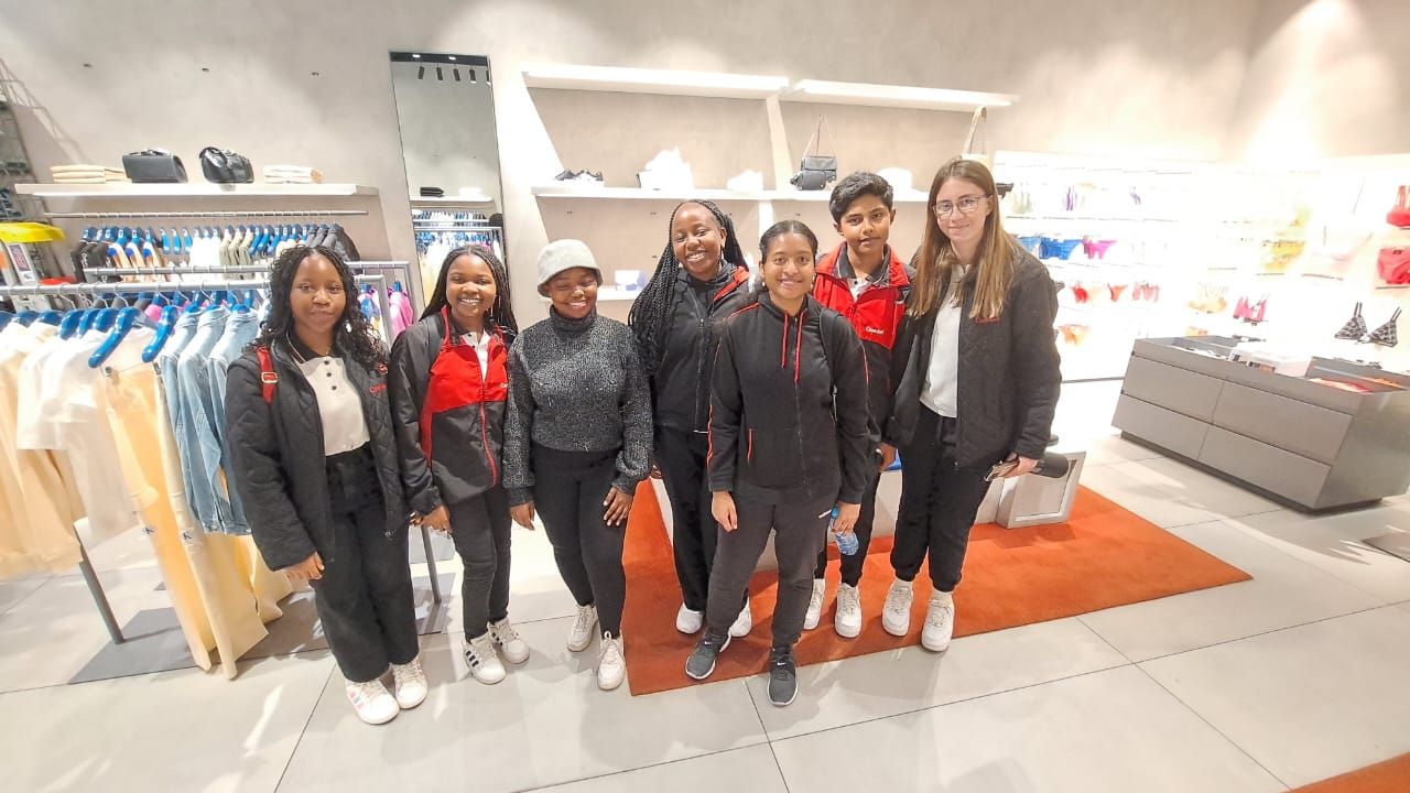 A group of people are posing for a picture in a store.