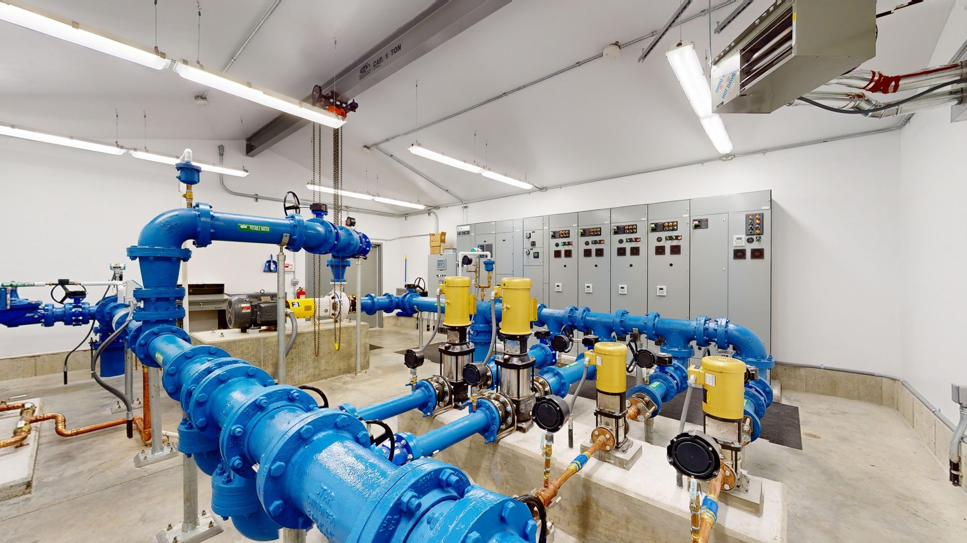 A room filled with lots of blue pipes and valves.