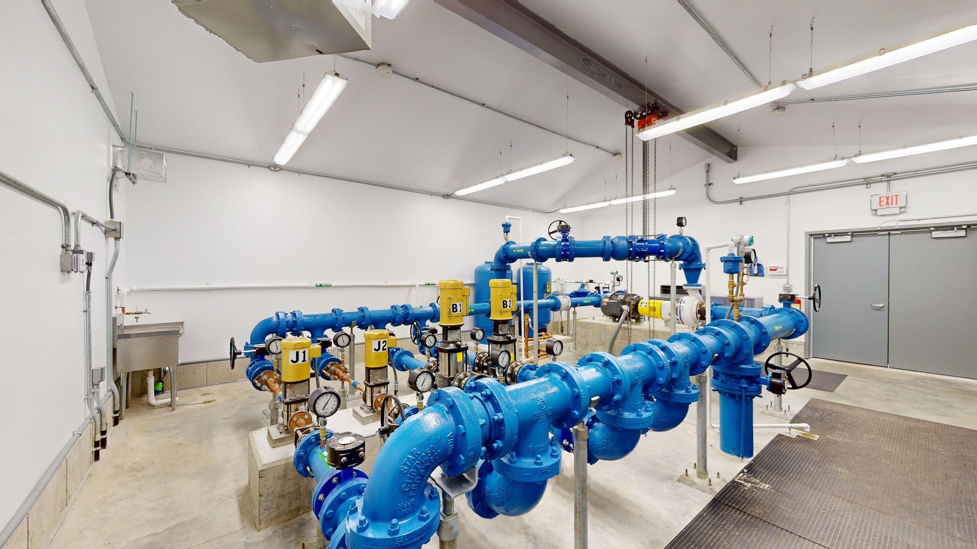 A room filled with lots of blue pipes and pumps.