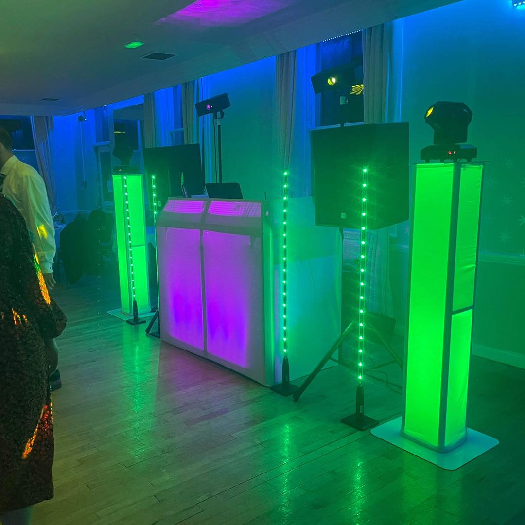 DJ setup with colorful lights at an event.