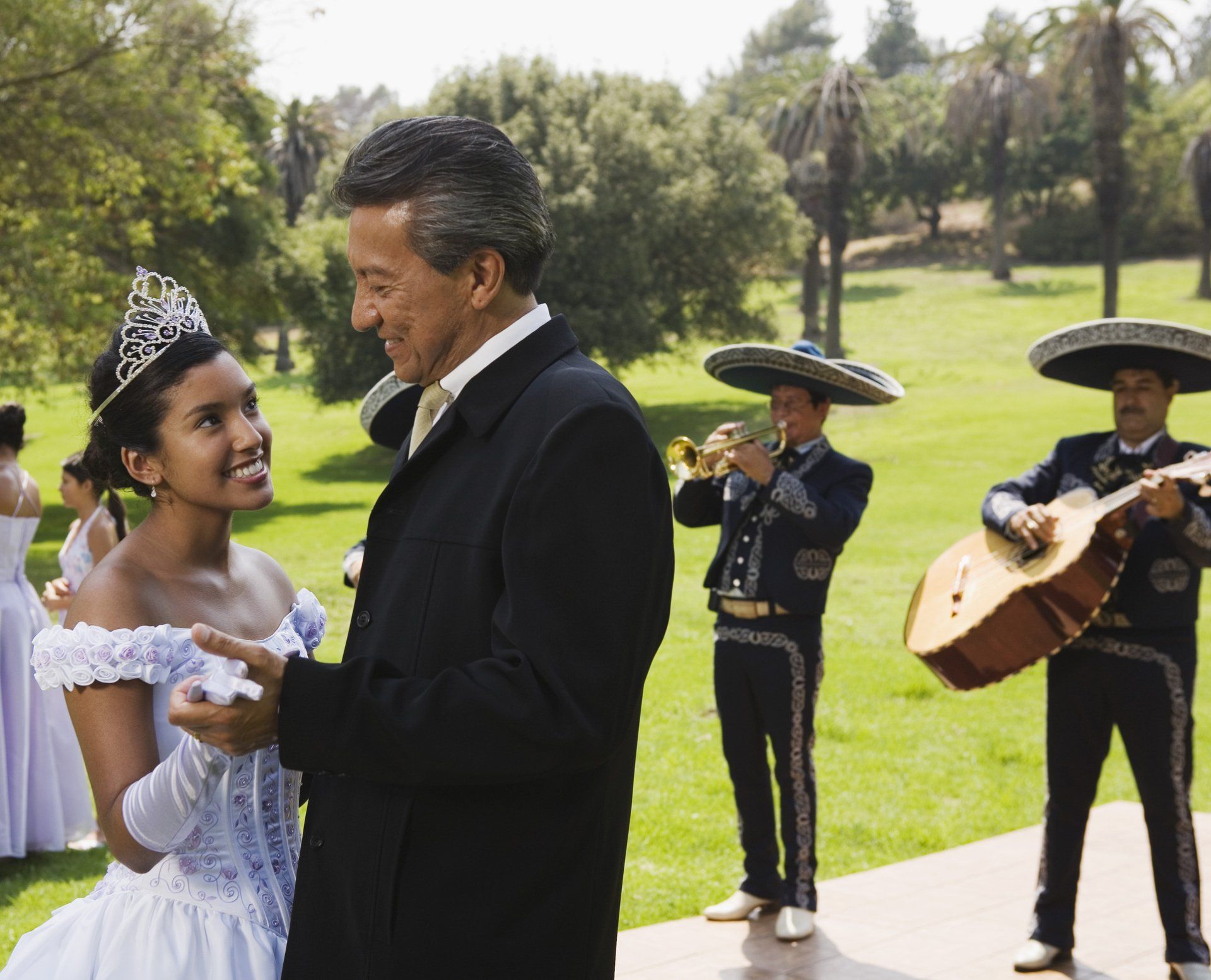 Grandfather and teenage girl dancing at quinceanera