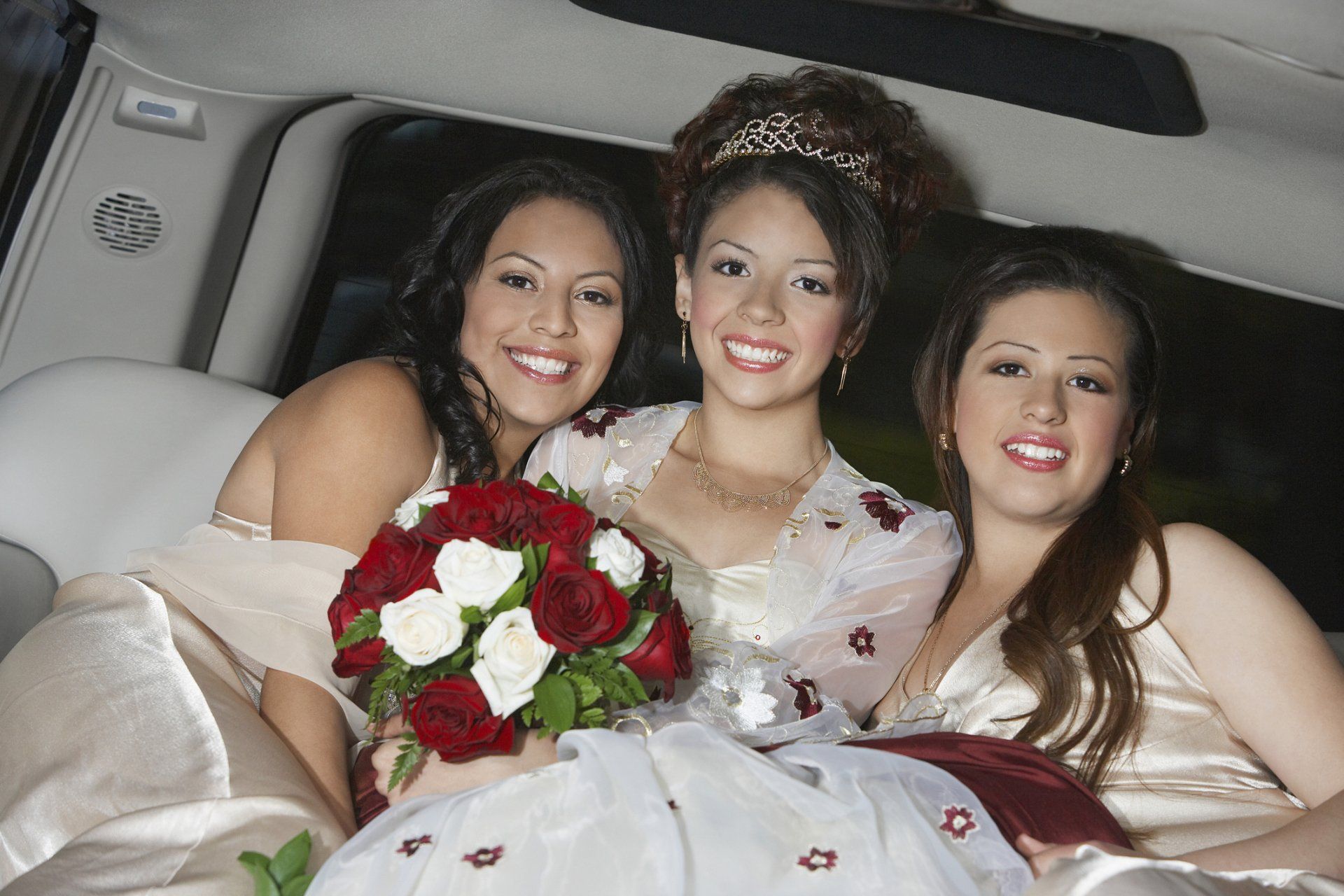 Girl (13-15) with friends in limousine at Quinceanera