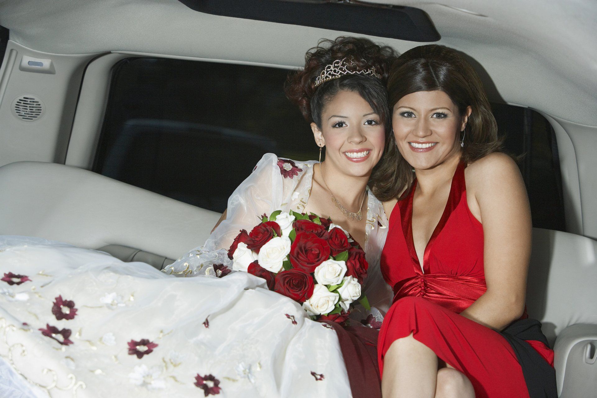 Girl (13-15) with mother in limousine at Quinceanera