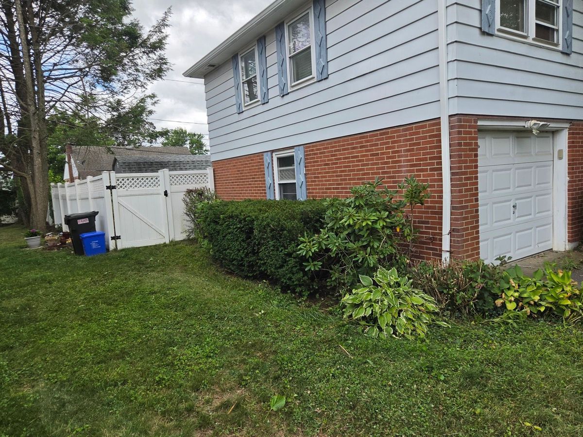 The same Allentown, PA home with the hedges trimmed down and pulled back off the siding and garage