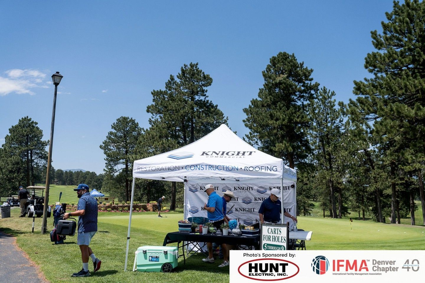 White tent at a golf course with 